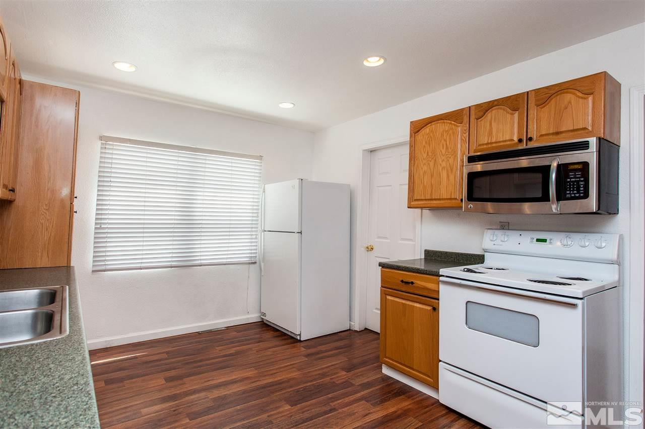 1045 Litch Court Reno, NV 89509 - Photo 7 of 18 a kitchen with stainless steel appliances a stove microwave and sink