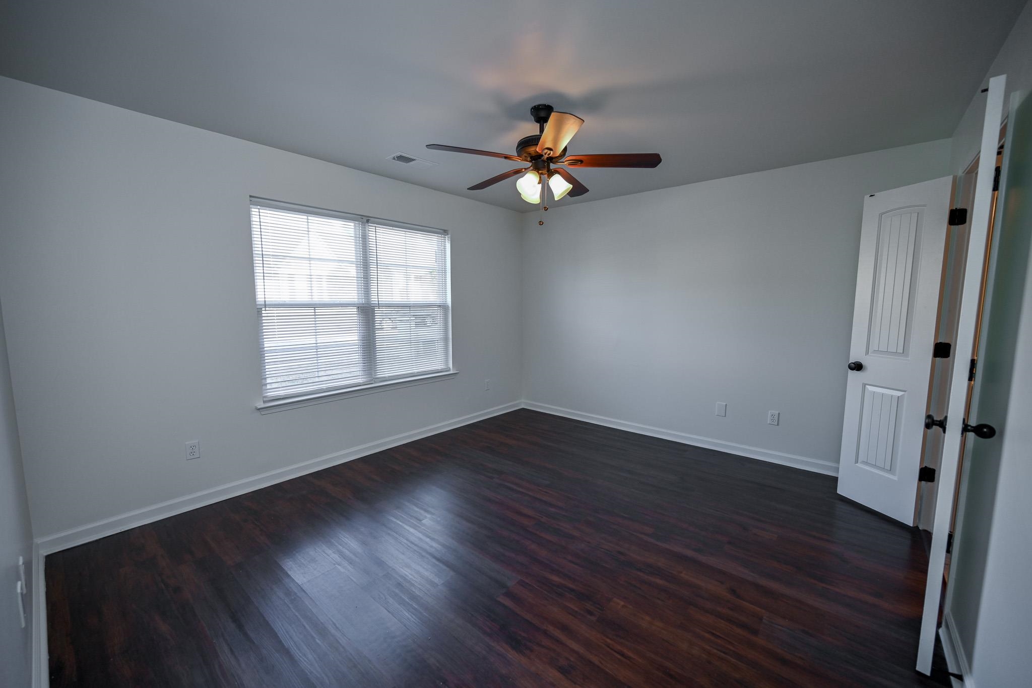 10249 Sterling Ridge Drive Cordova, TN 38018 - Photo 12 of 27 an empty room with wooden floor fan and windows