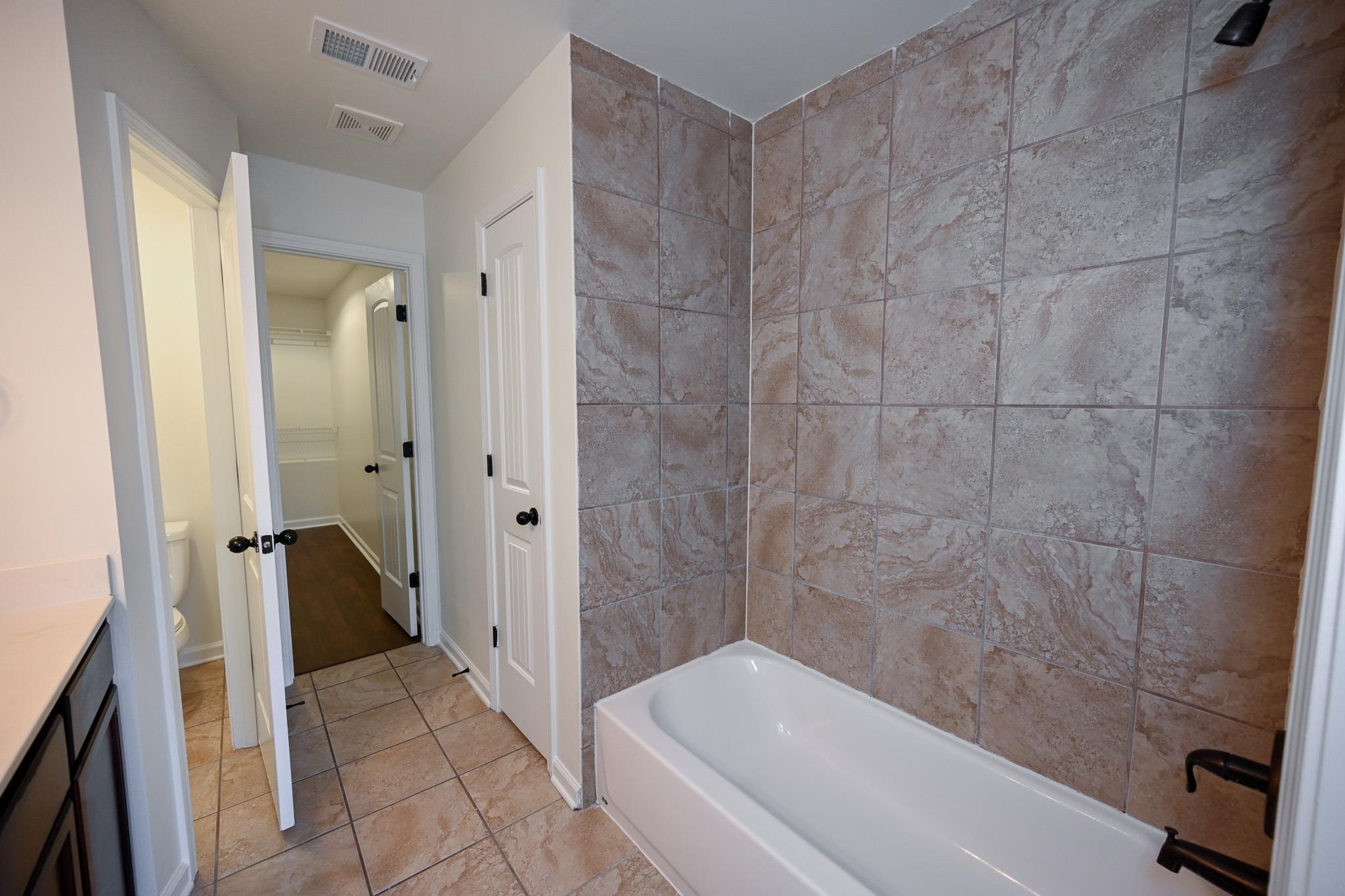 10249 Sterling Ridge Drive Cordova, TN 38018 - Photo 14 of 27 a bathroom with a tub and a shower
