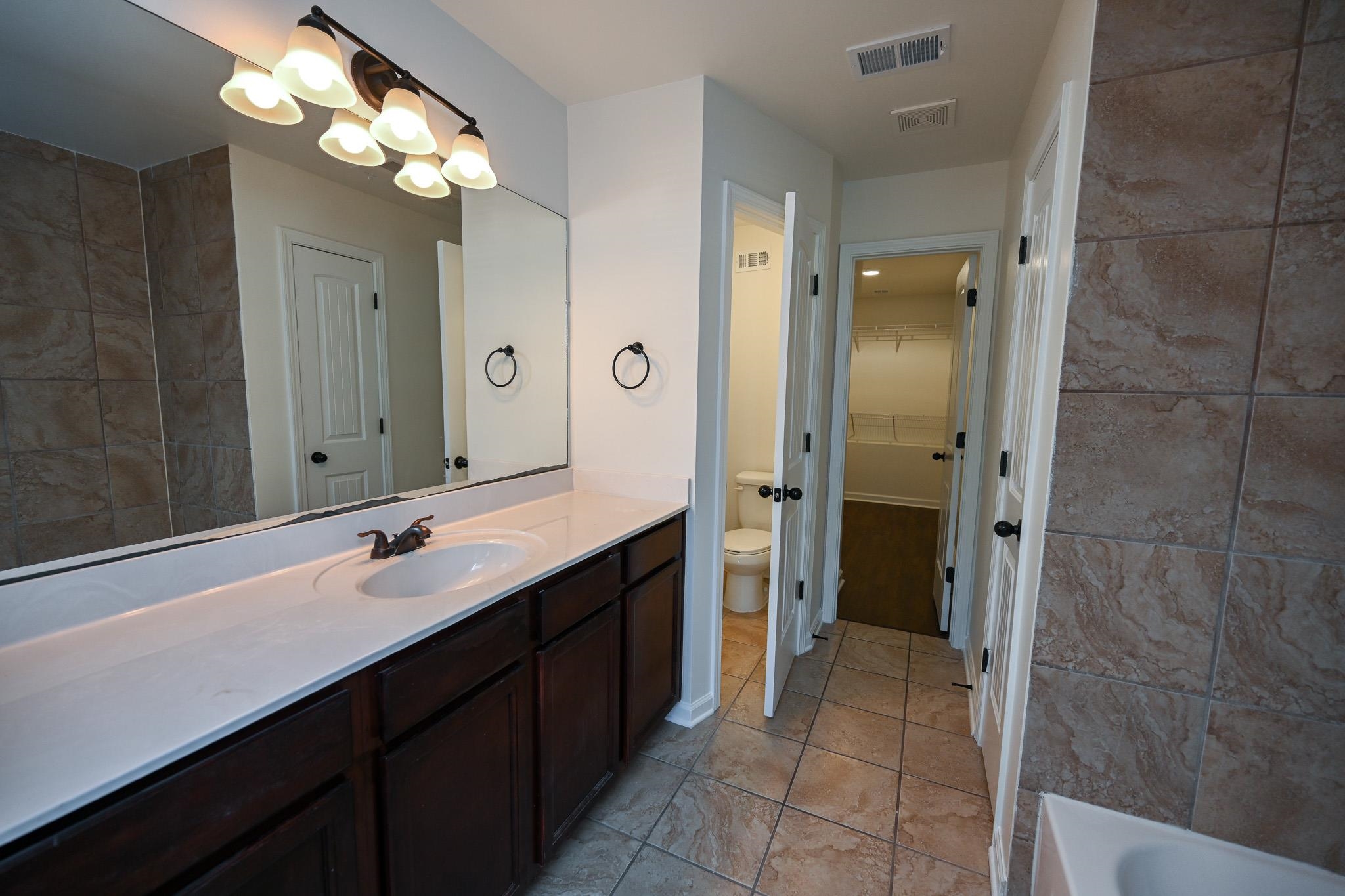 10249 Sterling Ridge Drive Cordova, TN 38018 - Photo 15 of 27 a bathroom with a double vanity sink and a mirror