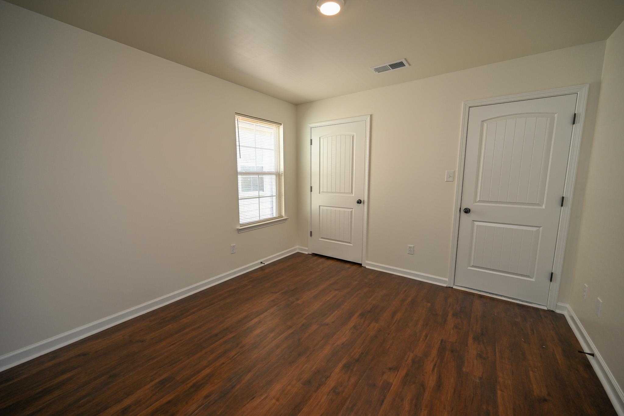 10249 Sterling Ridge Drive Cordova, TN 38018 - Photo 19 of 27 a view of an empty room with wooden floor and a window