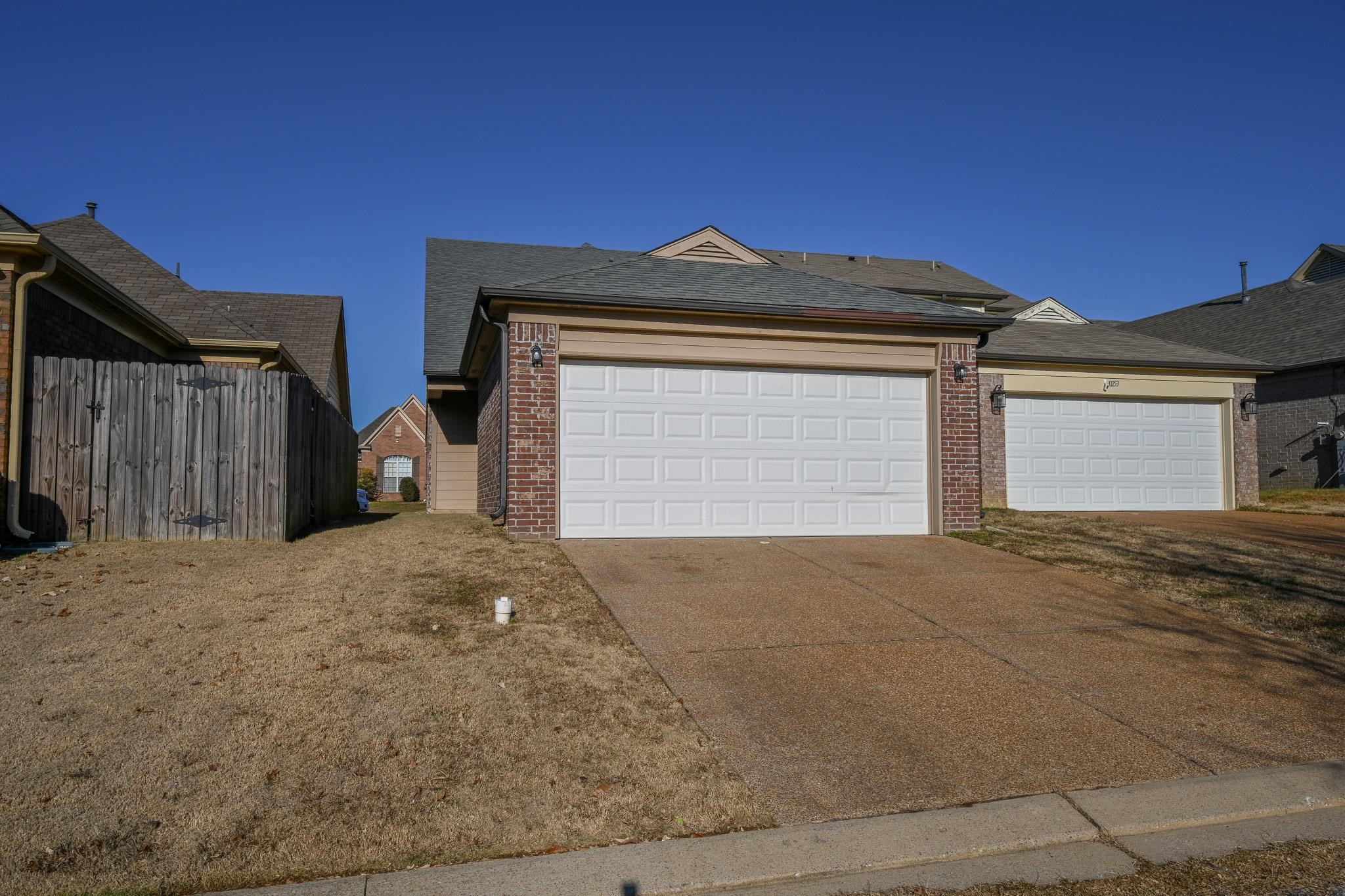 10249 Sterling Ridge Drive Cordova, TN 38018 - Photo 25 of 27 a front view of a house with a yard and garage