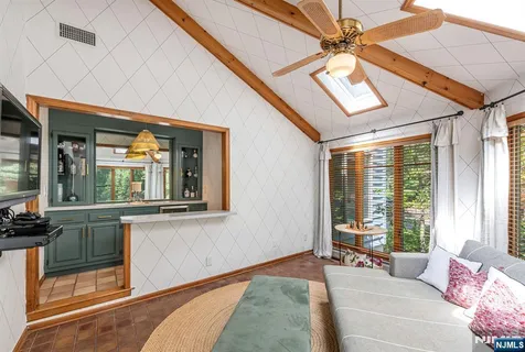 a bedroom with furniture and a large window