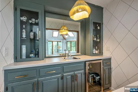a view of a kitchen with a sink and dishwasher cabinets with wooden floor