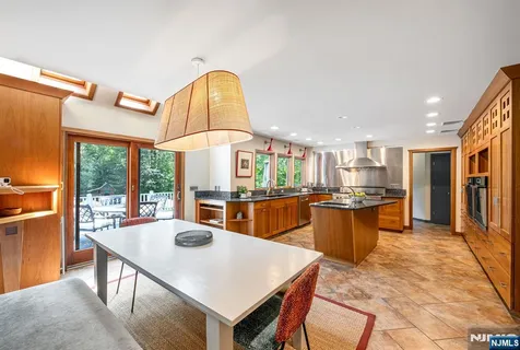 a kitchen with a table chairs and wooden floor