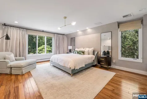 a bedroom with a large bed and a large window