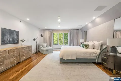 a spacious bedroom with a large bed and a window