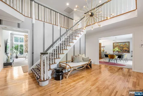 a view of entryway and dining room with wooden floor