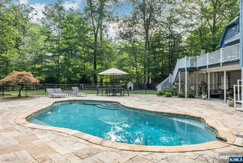 a view of a house with swimming pool and sitting area