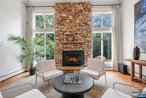 a living room with furniture a fireplace and a large window
