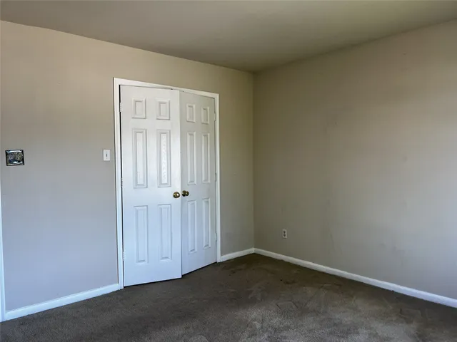 an empty room with closet area