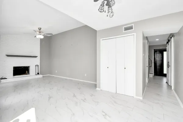 a view of an empty room with a fireplace