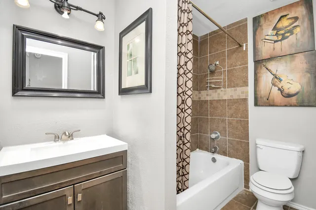 a bathroom with a sink a toilet and bathtub