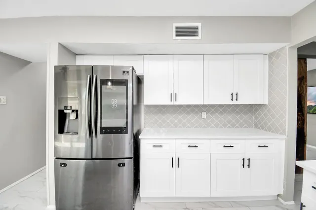 a kitchen with cabinets and stainless steel appliances