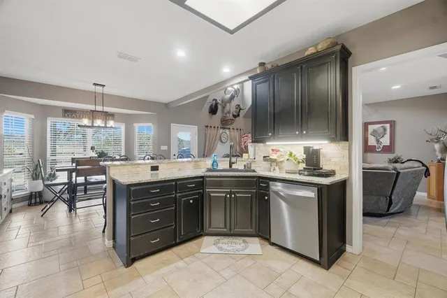 a kitchen with a sink counter top space appliances and cabinets