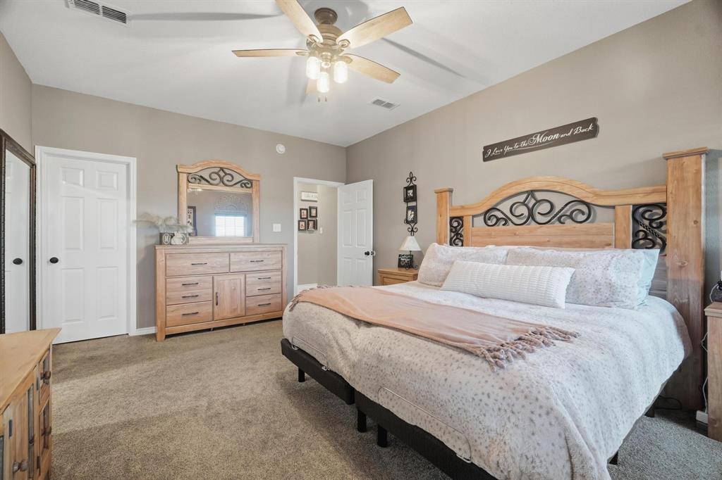 401 County Road 359, Unit B Merkel, TX 79536 - Photo 16 of 40 a spacious bedroom with a bed and a cabinets