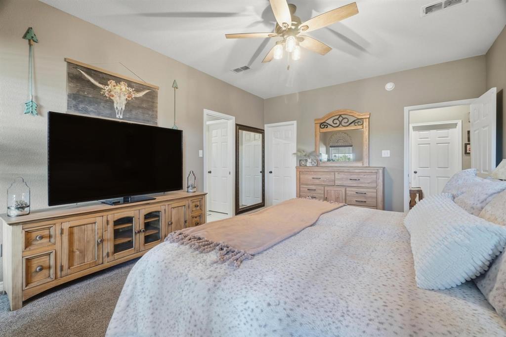 401 County Road 359, Unit B Merkel, TX 79536 - Photo 17 of 40 a bedroom with a bed and a flat screen tv
