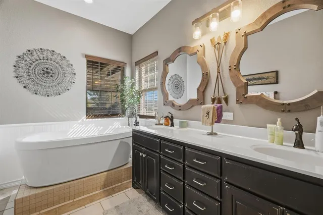 a bathroom with a tub sink and mirror