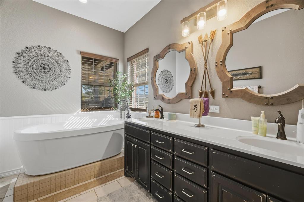 401 County Road 359, Unit B Merkel, TX 79536 - Photo 18 of 40 a bathroom with a tub sink and mirror