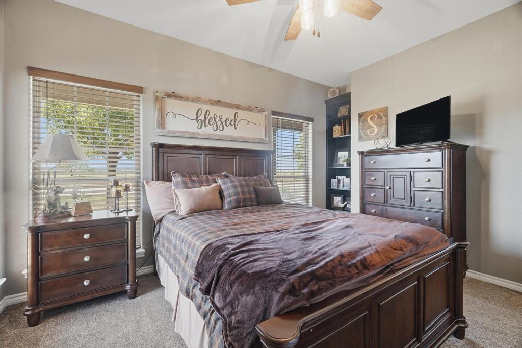 401 County Road 359, Unit B Merkel, TX 79536 - Photo 19 of 40 a bedroom with a bed and a flat tv screen on dresser