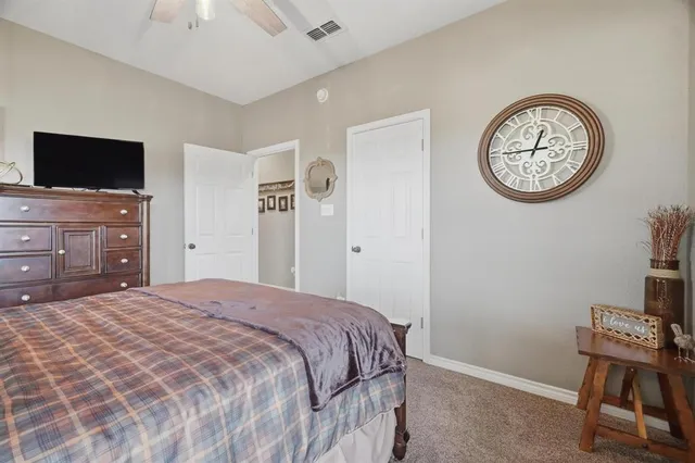 a bedroom with a bed and a television