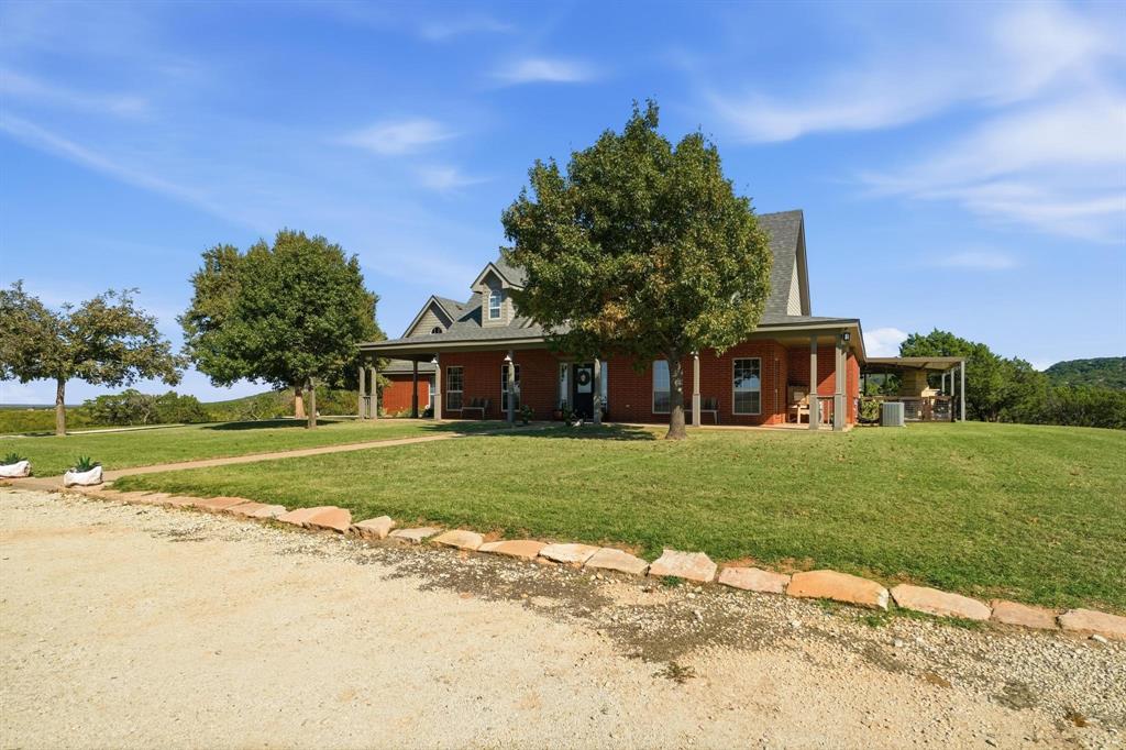 401 County Road 359, Unit B Merkel, TX 79536 - Photo 2 of 40 a front view of a house with a garden and trees