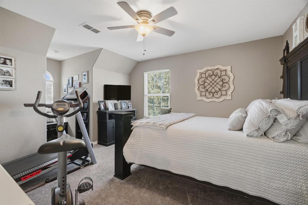 401 County Road 359, Unit B Merkel, TX 79536 - Photo 23 of 40 a bedroom with a bed a flat screen tv and a window