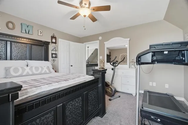 a bedroom with a bed and a dresser