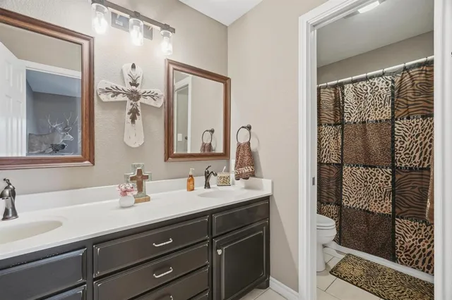 a bathroom with a double vanity sink mirror and double