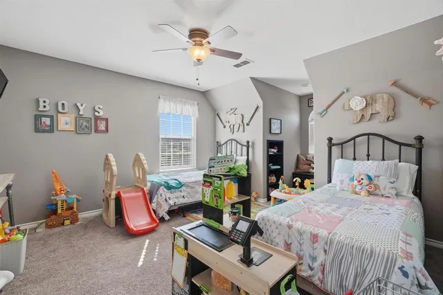 a bedroom with bed and a chandelier