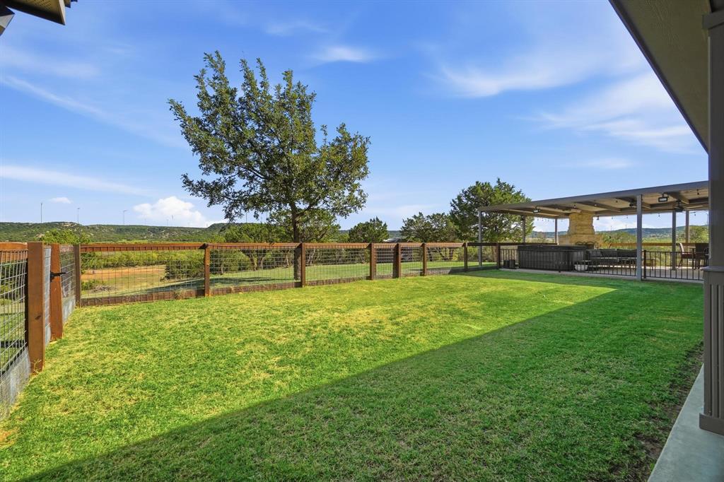 401 County Road 359, Unit B Merkel, TX 79536 - Photo 30 of 40 a view of a garden with a building in the background