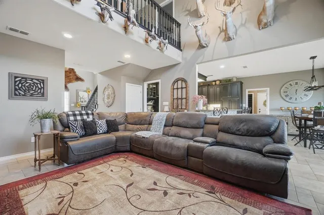 a living room with furniture and a chandelier