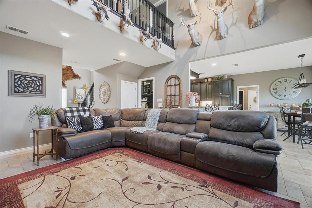 401 County Road 359, Unit B Merkel, TX 79536 - Photo 6 of 40 a living room with furniture and a chandelier