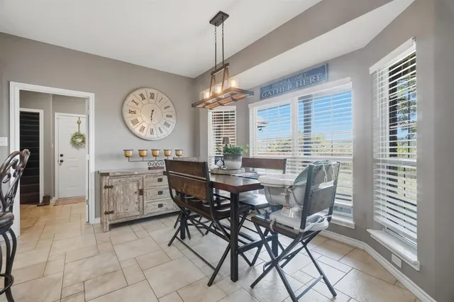a dining room with furniture and window