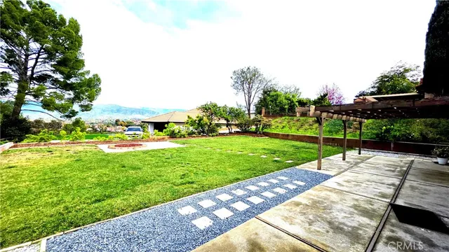 a view of a backyard with sitting area