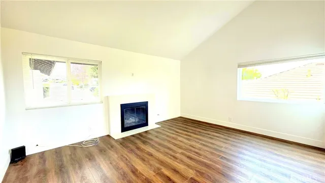 a view of an empty room and wooden floor