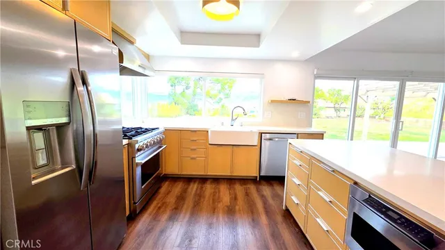 a kitchen with wooden floors and wooden cabinets