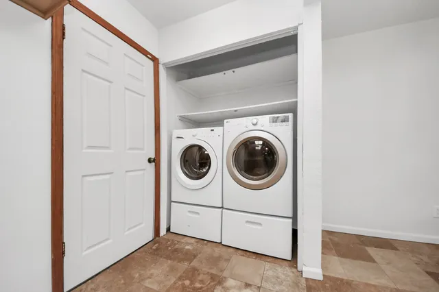 an empty room with wooden floor and window
