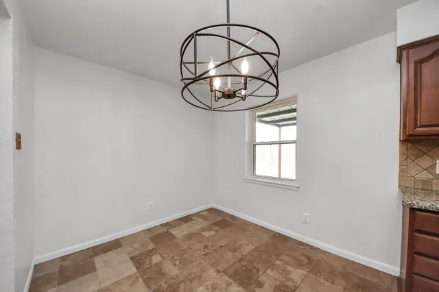 a kitchen with stainless steel appliances granite countertop a sink a stove cabinets and a counter top space