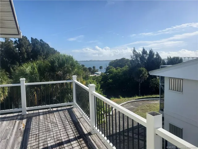 a view of a balcony with wooden floor