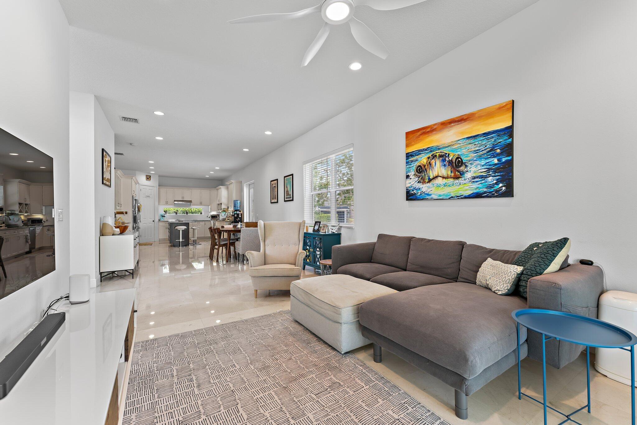 807 Xanadu Place Jupiter, FL 33477 - Photo 11 of 36 a living room with furniture and a view of kitchen
