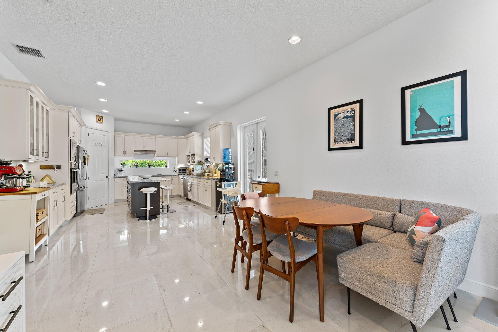 807 Xanadu Place Jupiter, FL 33477 - Photo 12 of 36 a living room with furniture and kitchen view