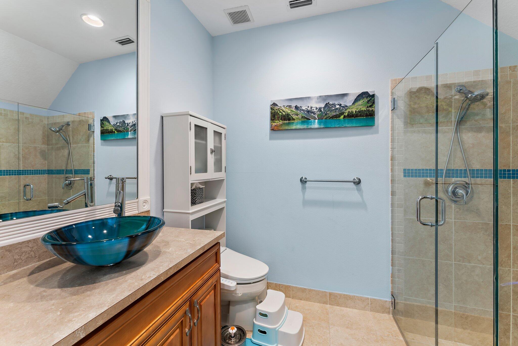 807 Xanadu Place Jupiter, FL 33477 - Photo 17 of 36 a bathroom with a granite countertop sink a toilet a mirror and shower