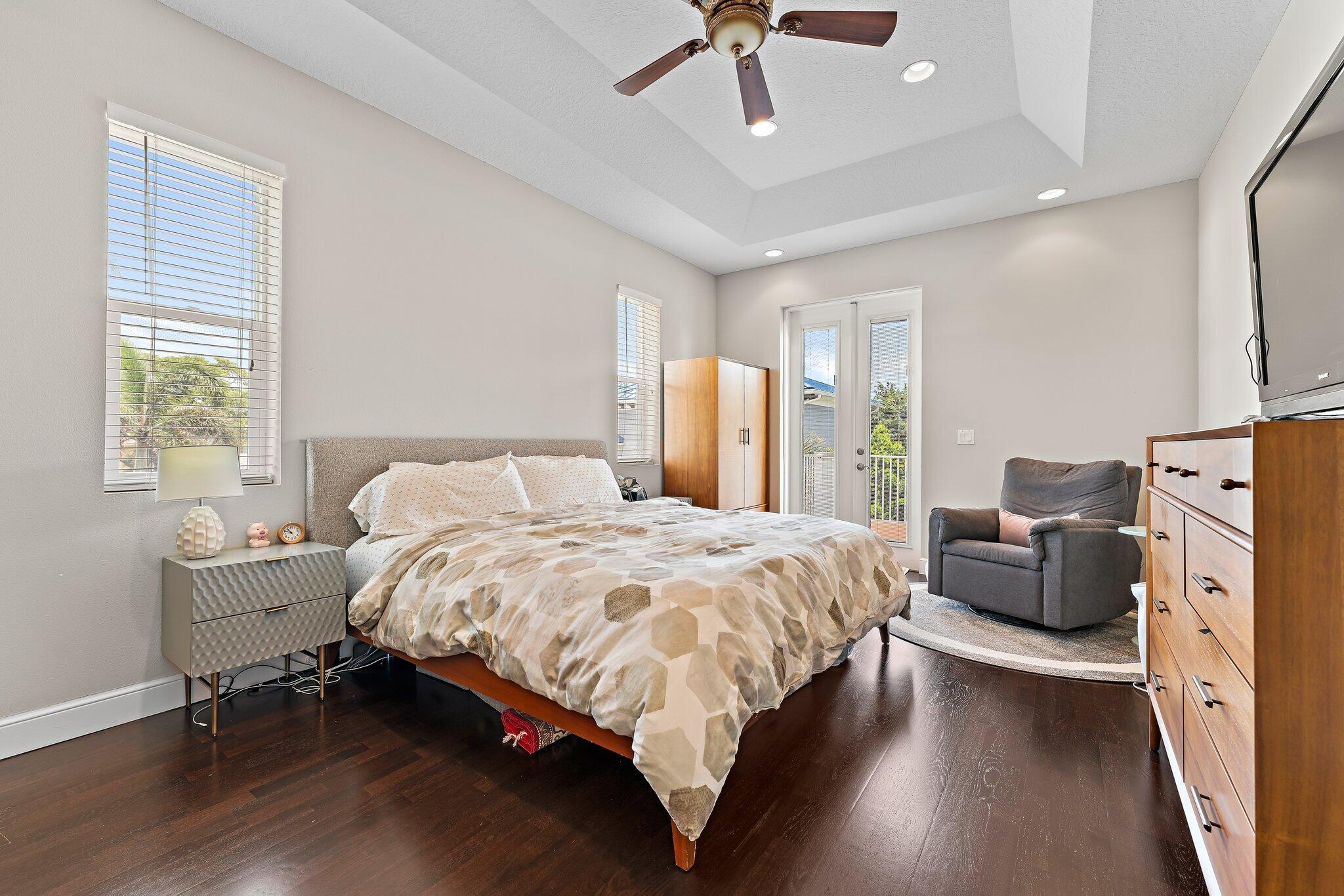 807 Xanadu Place Jupiter, FL 33477 - Photo 19 of 36 a bed room with a bed and a couch