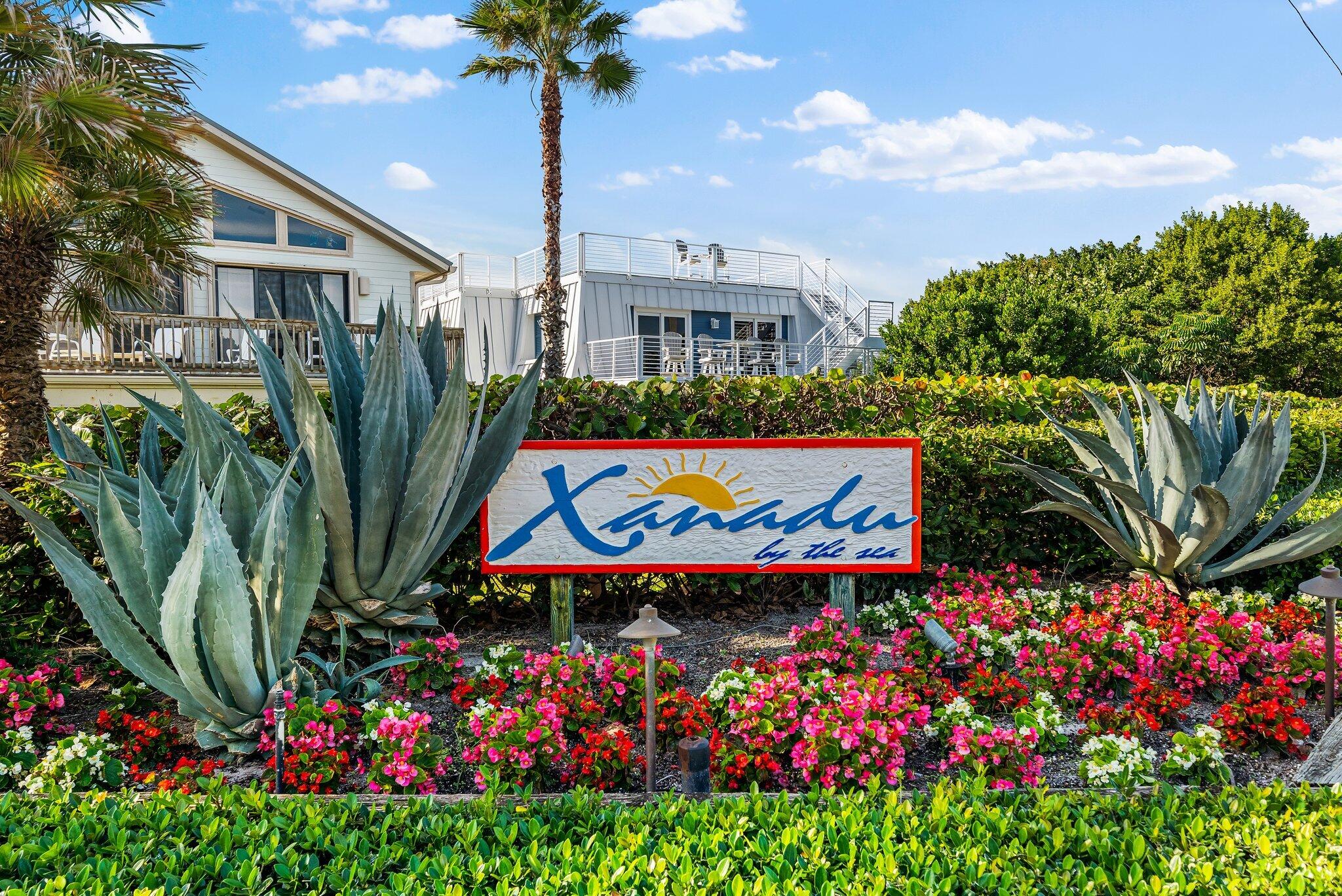 807 Xanadu Place Jupiter, FL 33477 - Photo 36 of 36 a sign that is in front of flowers