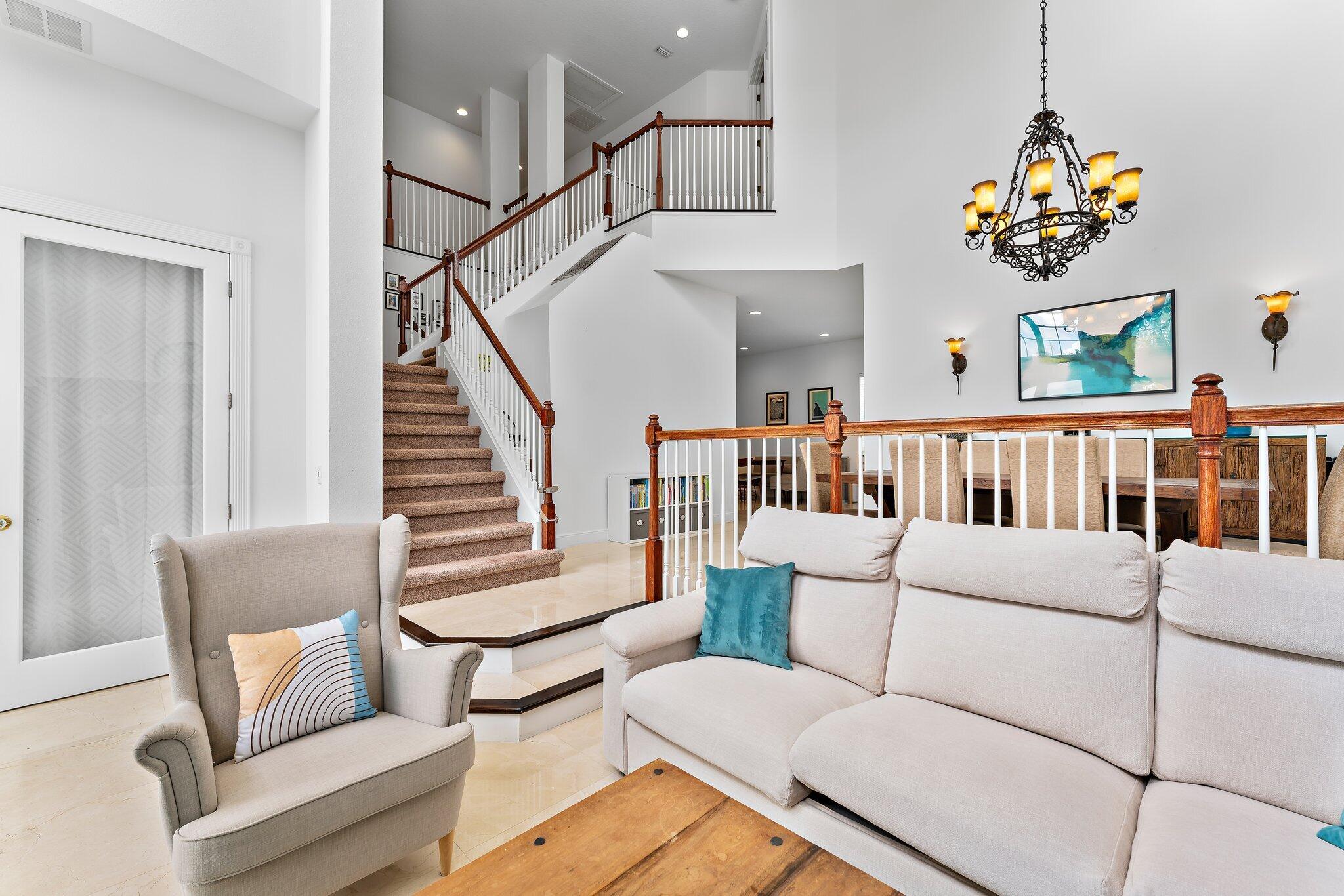 807 Xanadu Place Jupiter, FL 33477 - Photo 6 of 36 a living room with furniture and a baby crib