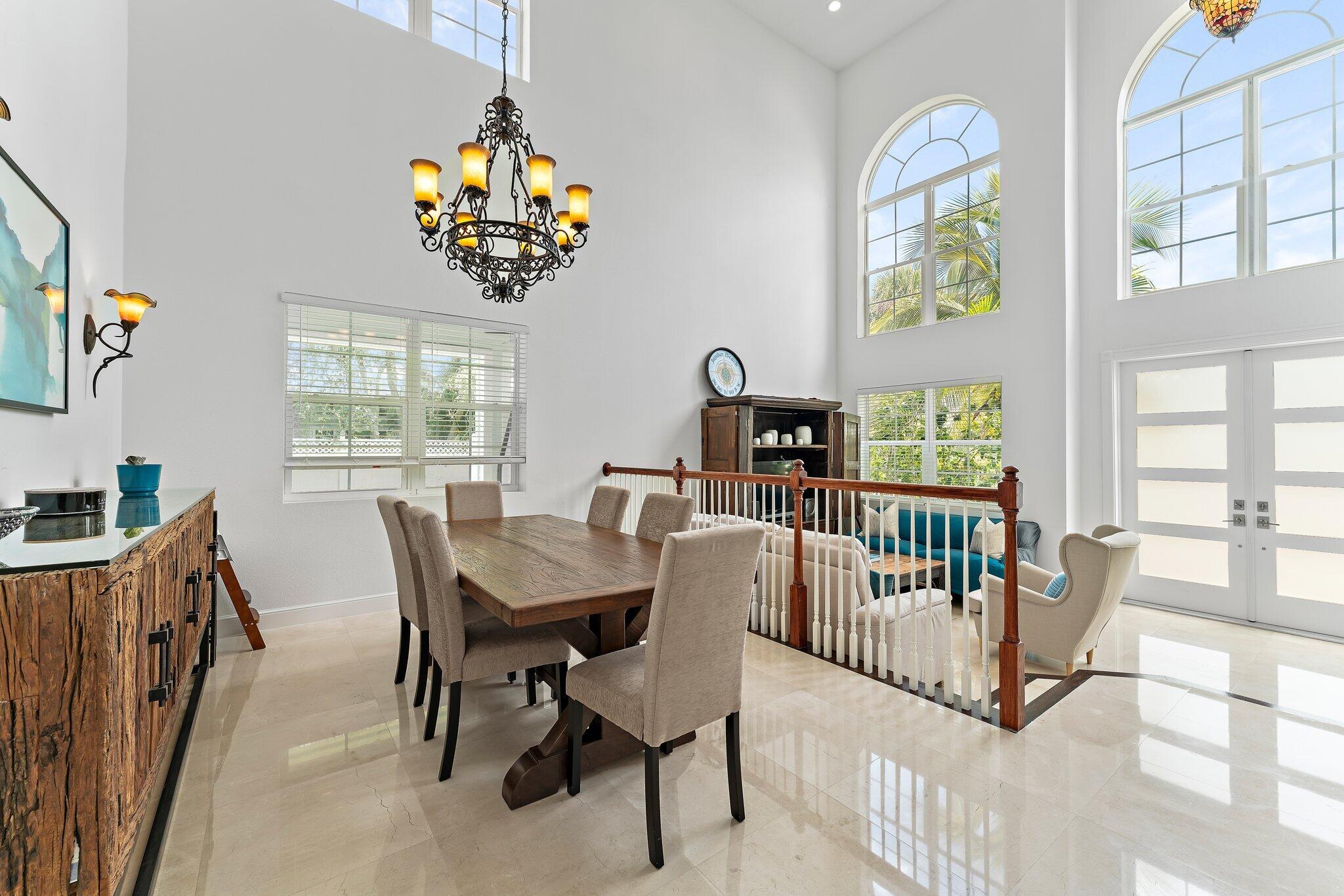 807 Xanadu Place Jupiter, FL 33477 - Photo 8 of 36 a view of a dining room with furniture a chandelier and a window