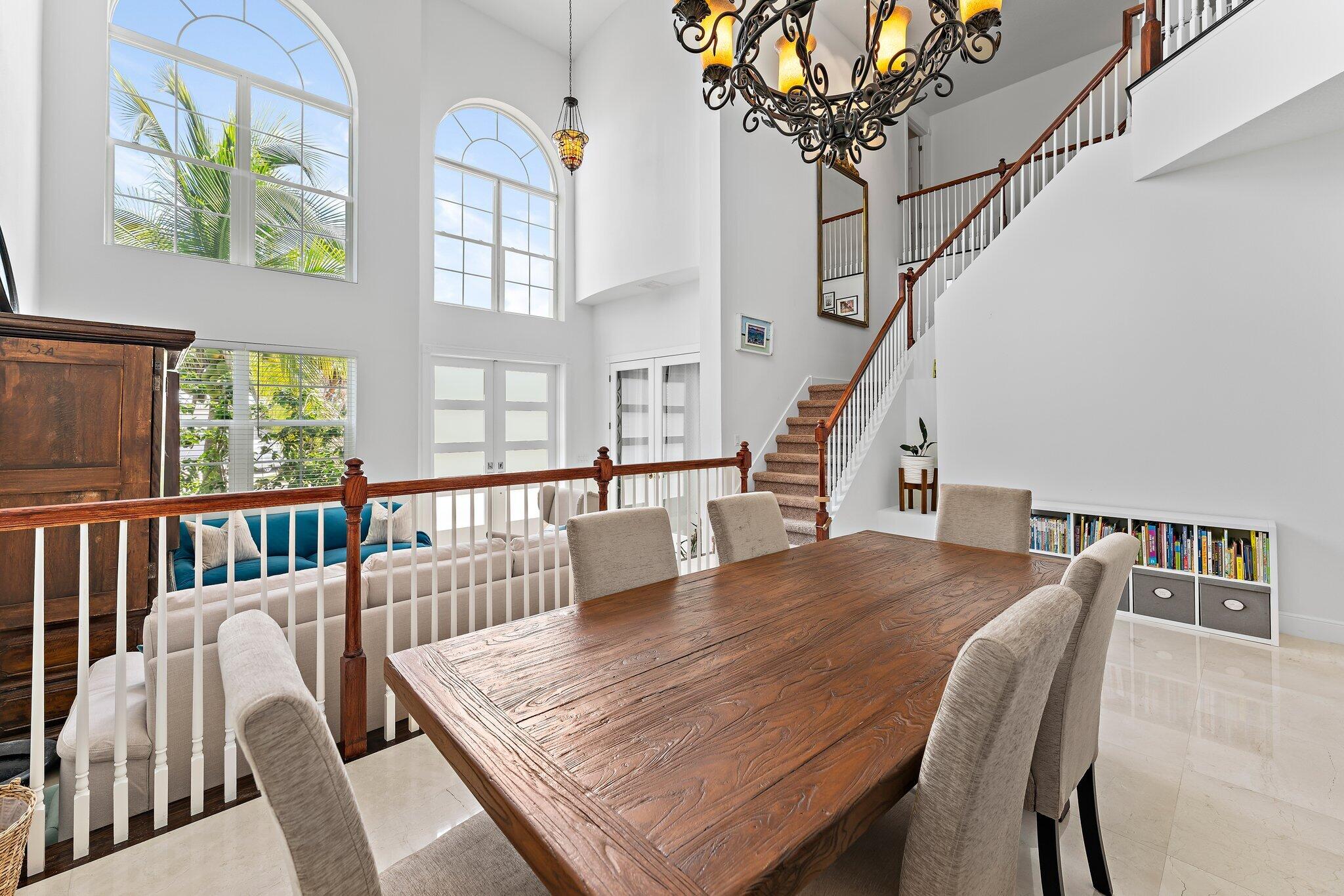 807 Xanadu Place Jupiter, FL 33477 - Photo 9 of 36 a dining room with furniture a chandelier and wooden floor