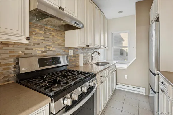 a kitchen with stainless steel appliances granite countertop a stove and a sink
