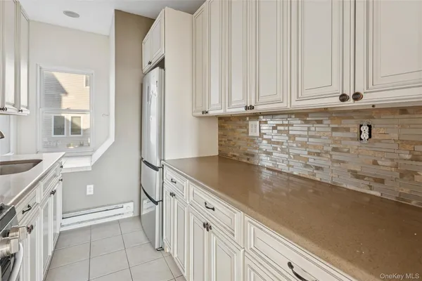 a kitchen with granite countertop a sink and a stove